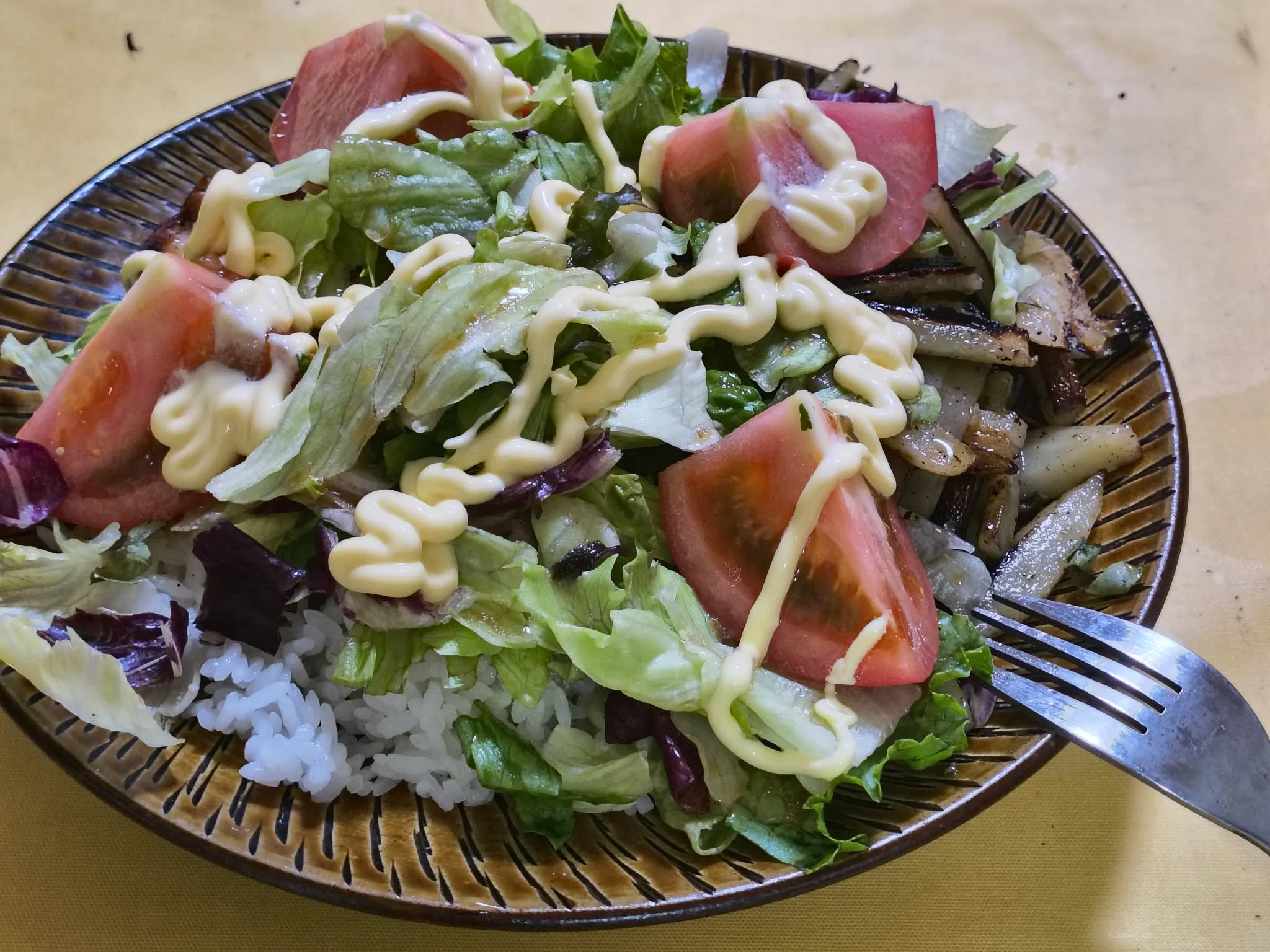 A single-plate dinner: chicken, potatoes, and scattered greens