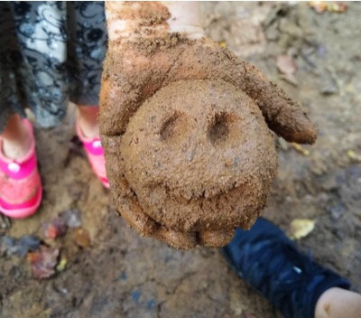 A camper's creation: a smiling mud ball.