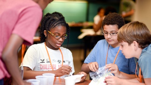 Three kids doing a science project