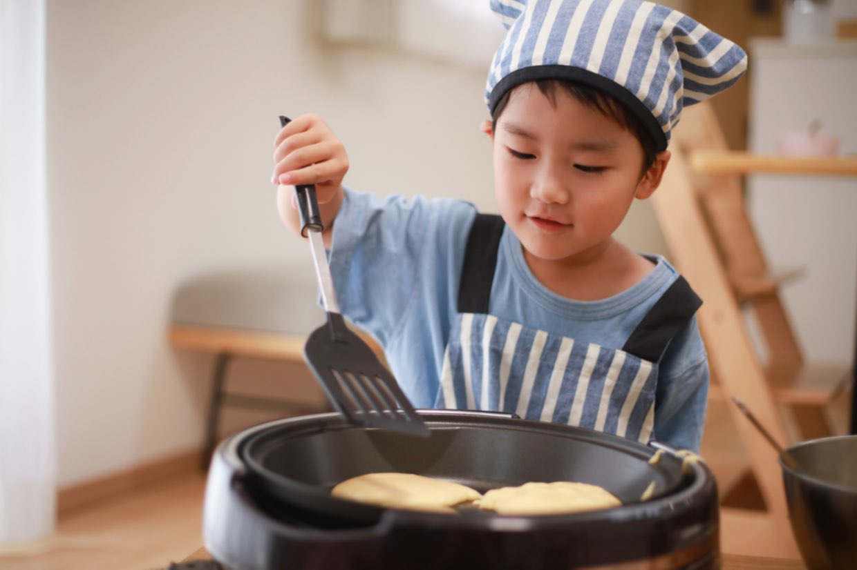 kid cooking a pancake