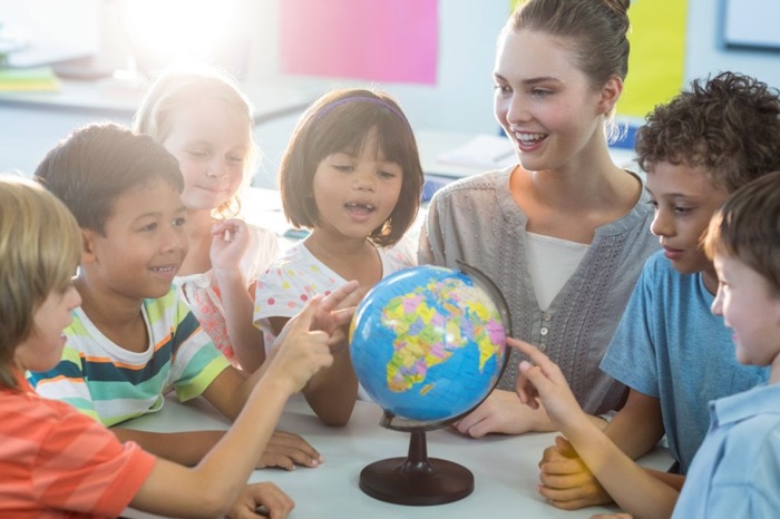 children learning around a globe