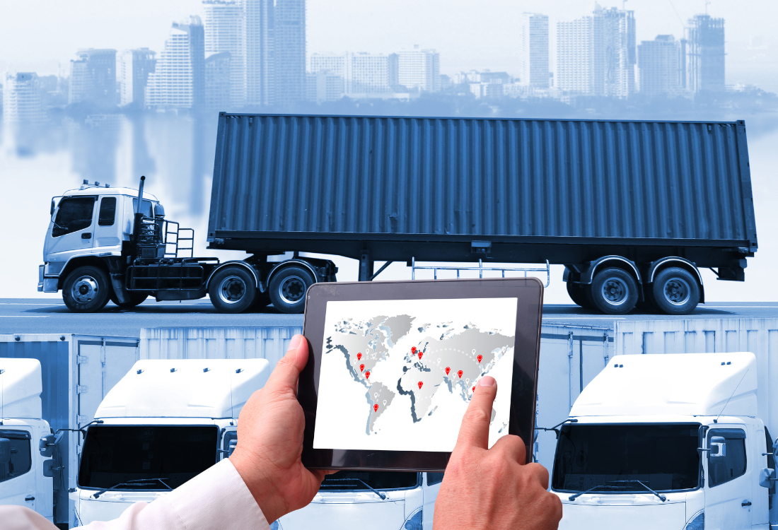 A logistics manager on a tablet coordinating a fleet of trucks, highlighting the key traits of a modern haulage and logistics company to ensure optimal operations in freight road transport.