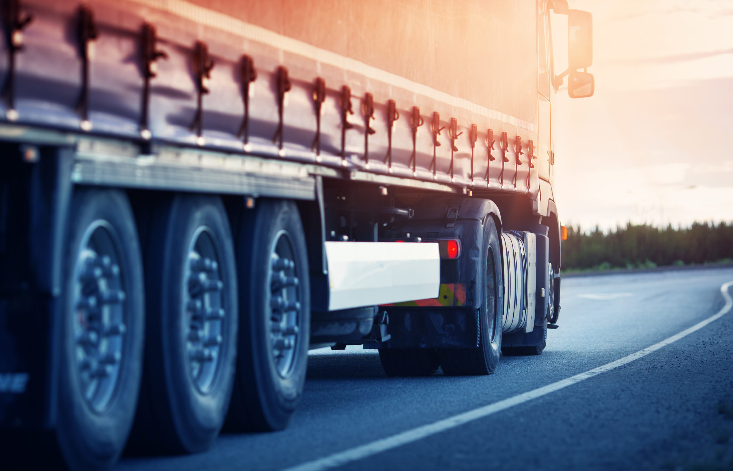 A close-up of a haulage truck on the road, highlighting the transport and
haulage industry's efforts to tackle the hidden costs of empty lorries through
technological innovations and optimised logistics solutions.