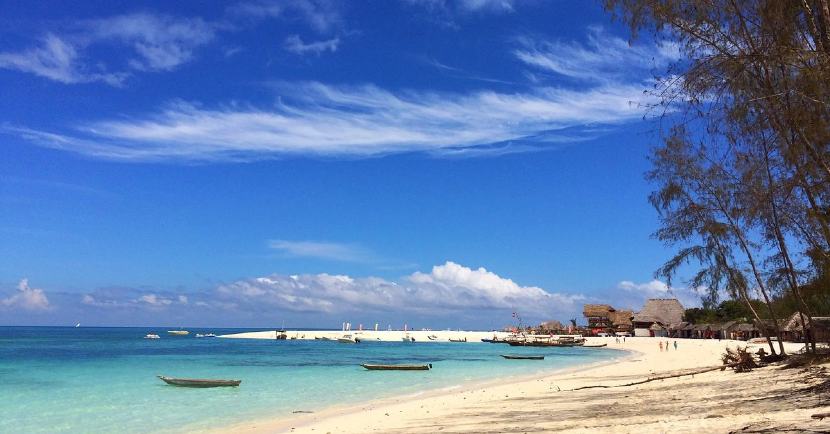 Zanzibar white sand beach with traditional boats