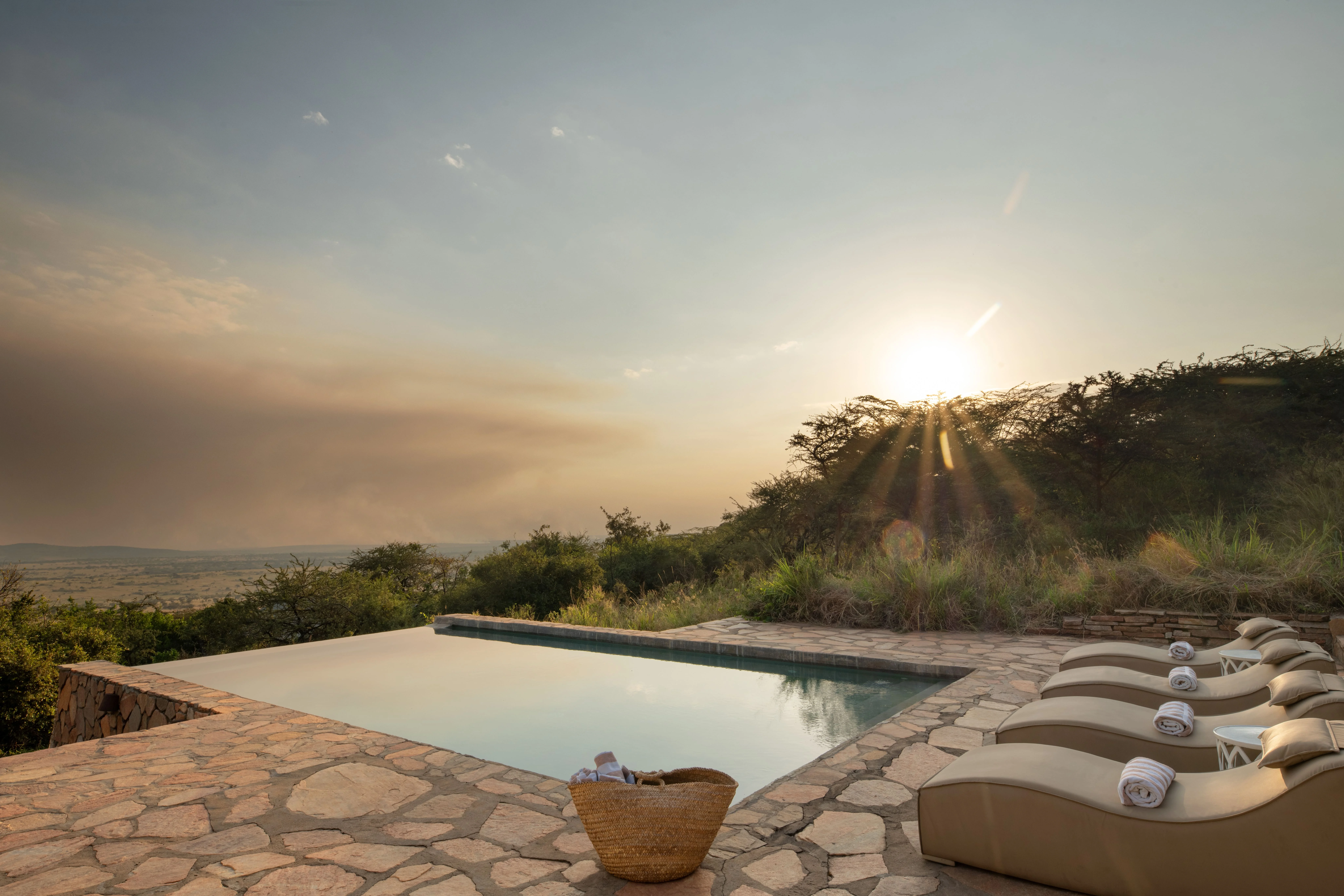 Luxury safari lodge pool at sunset