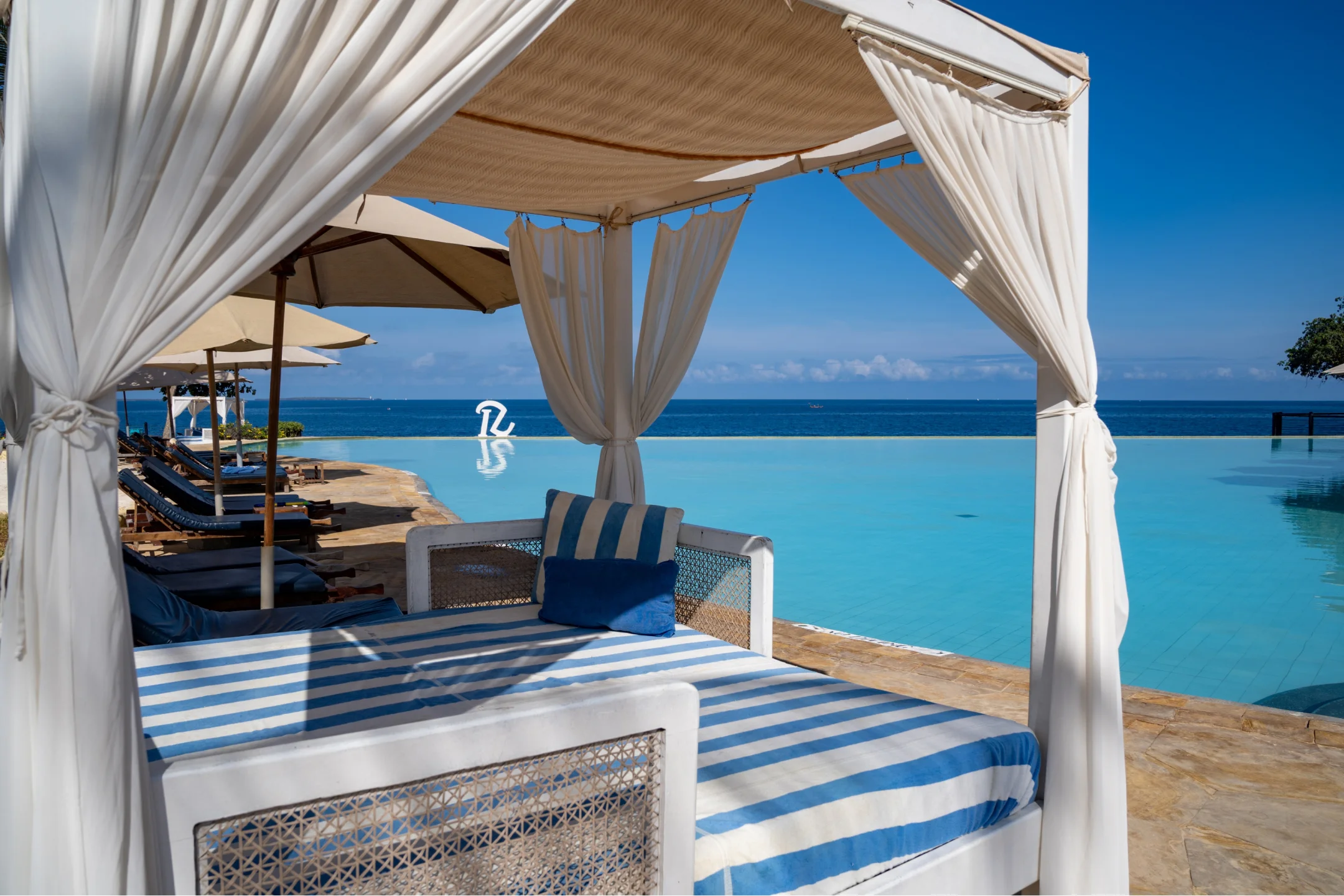 Beach cabana beside pool with ocean view