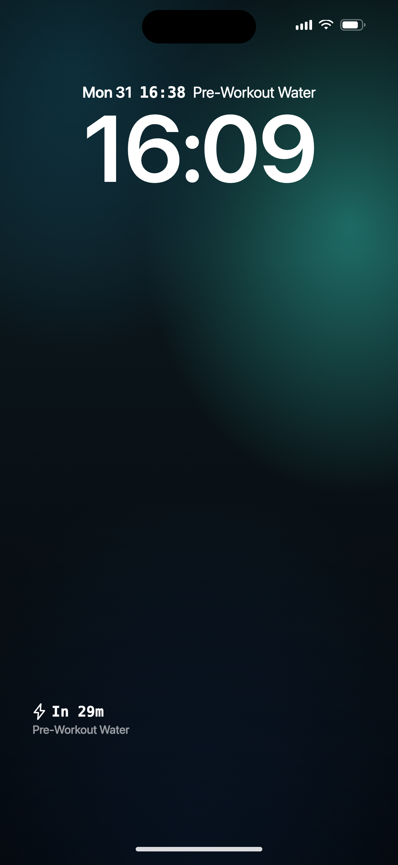 An iPhone Lock Screen with the KEXBI Up Next widget installed. The Rectangular widget sits under the clock, showing a glyph plus 'In 22m' as the hero line and the next item name beneath it.