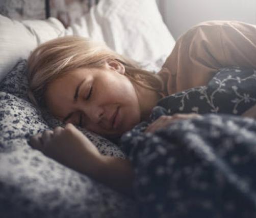 A woman sleeping in her bed