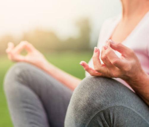 A person in a meditative pose outdoors