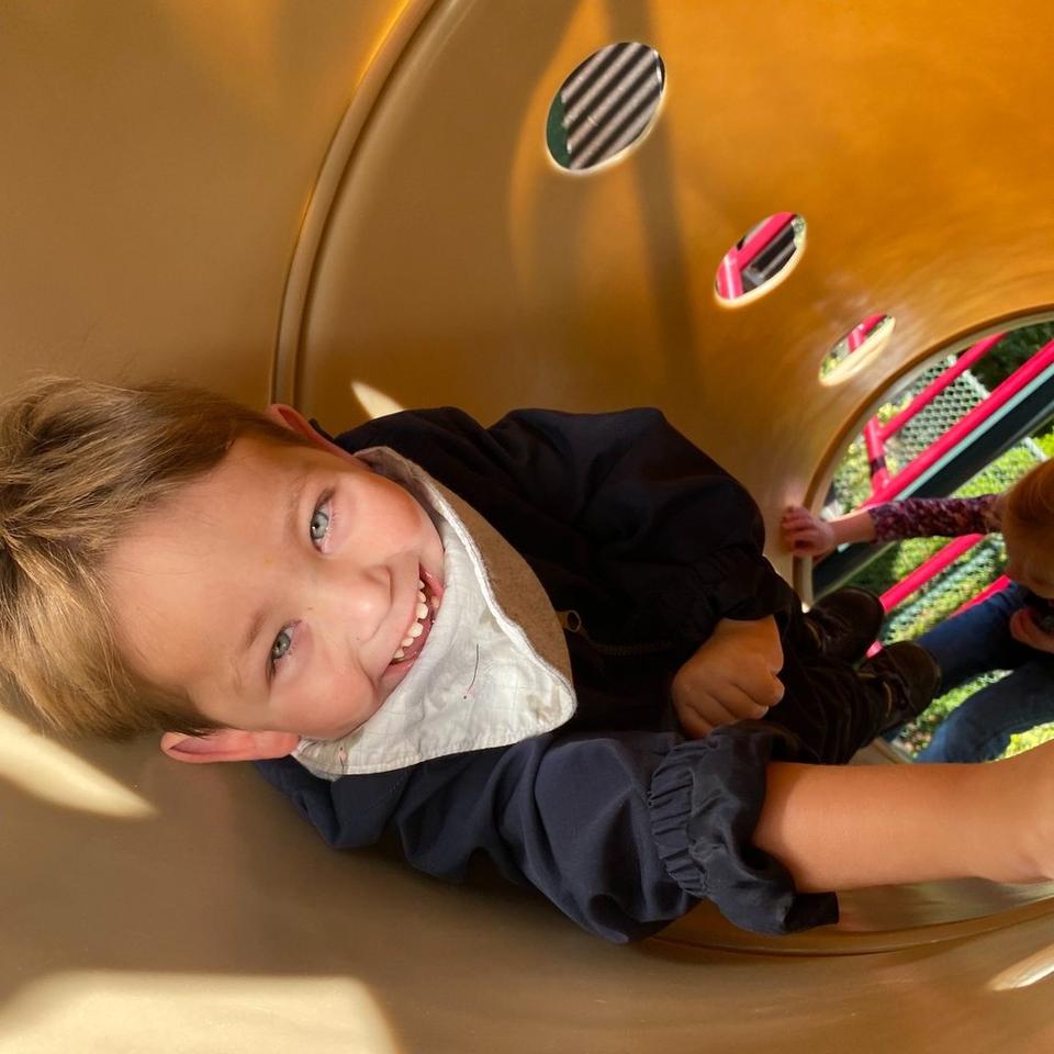 Alden, a child with medical complexities, smiling at school