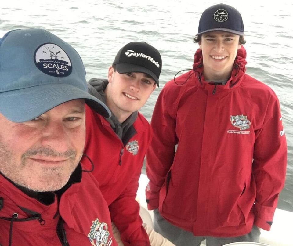 Cystic Fibrosis Dad and Advocate Bob Coughlin fishing on a boat with his sons.
