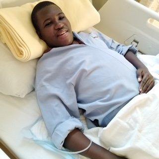 Alvin lying in a medical bed