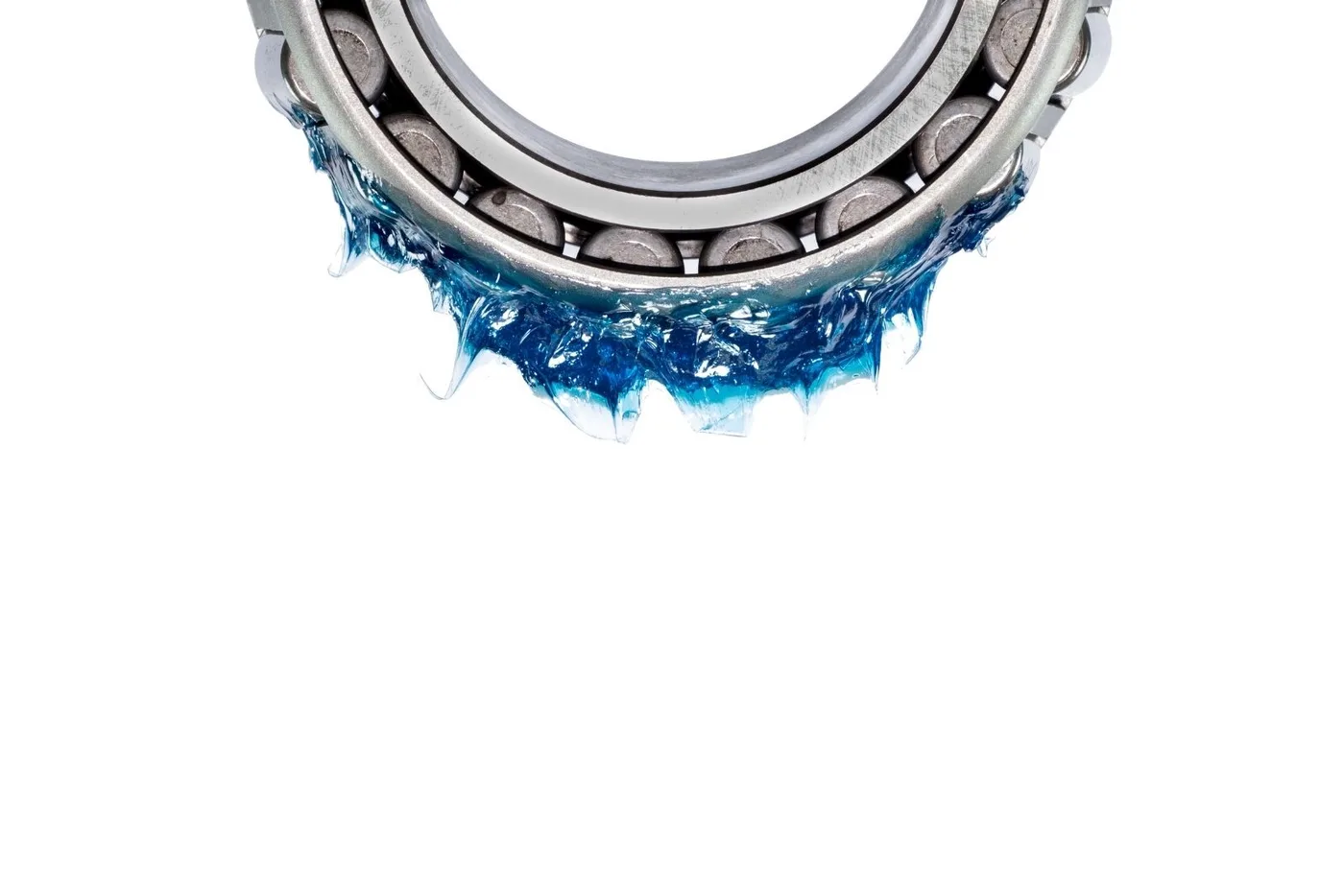 Roller bearing with blue grease hanging in clumps from the rollers