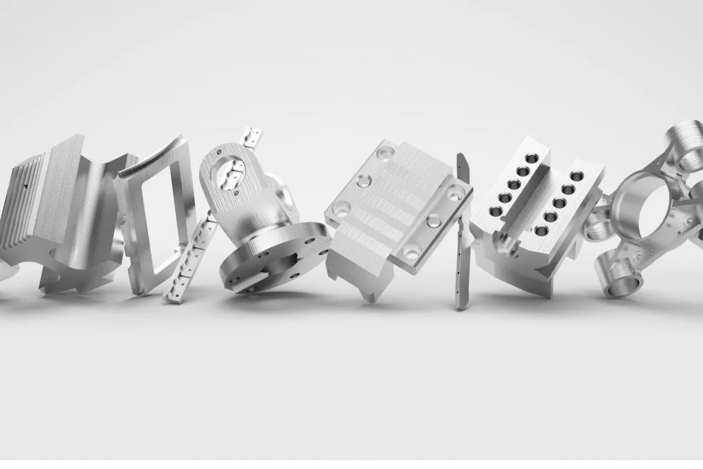 Row of machined aluminium parts with holes, slots and flanges