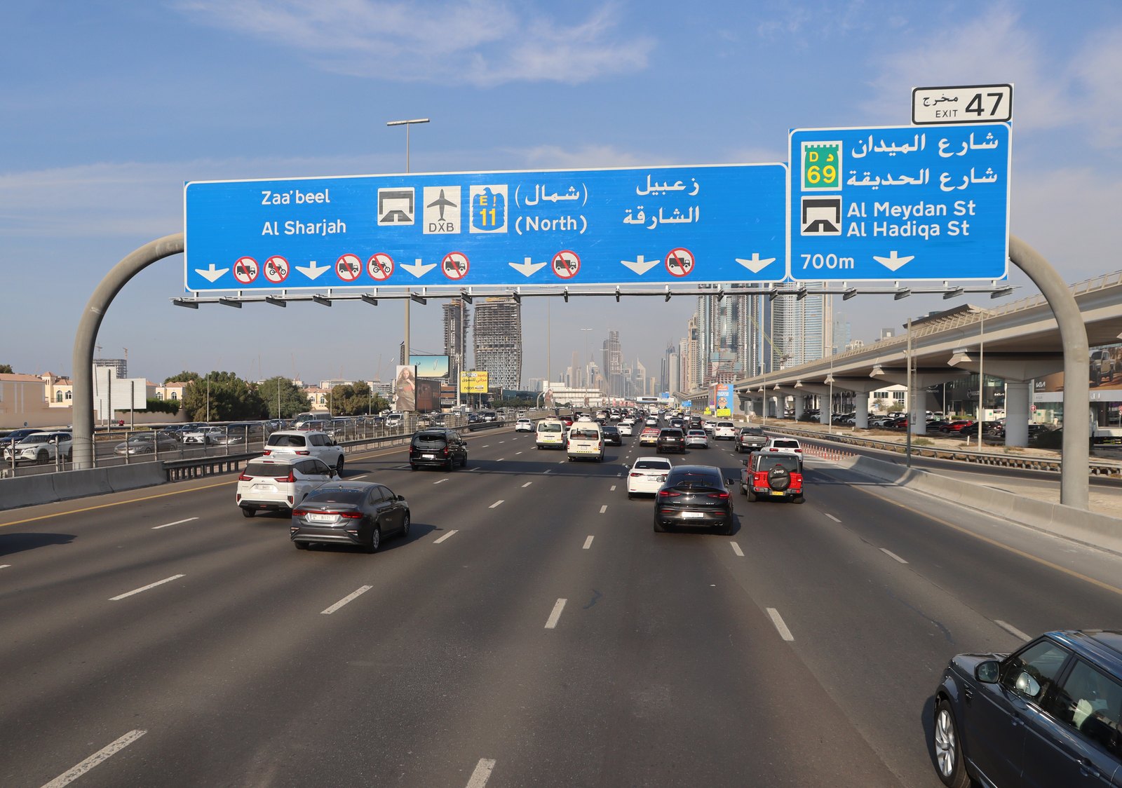 Dubai road signs and traffic on Sheikh Zayed Road, illustrating why mobility matters for property investors
