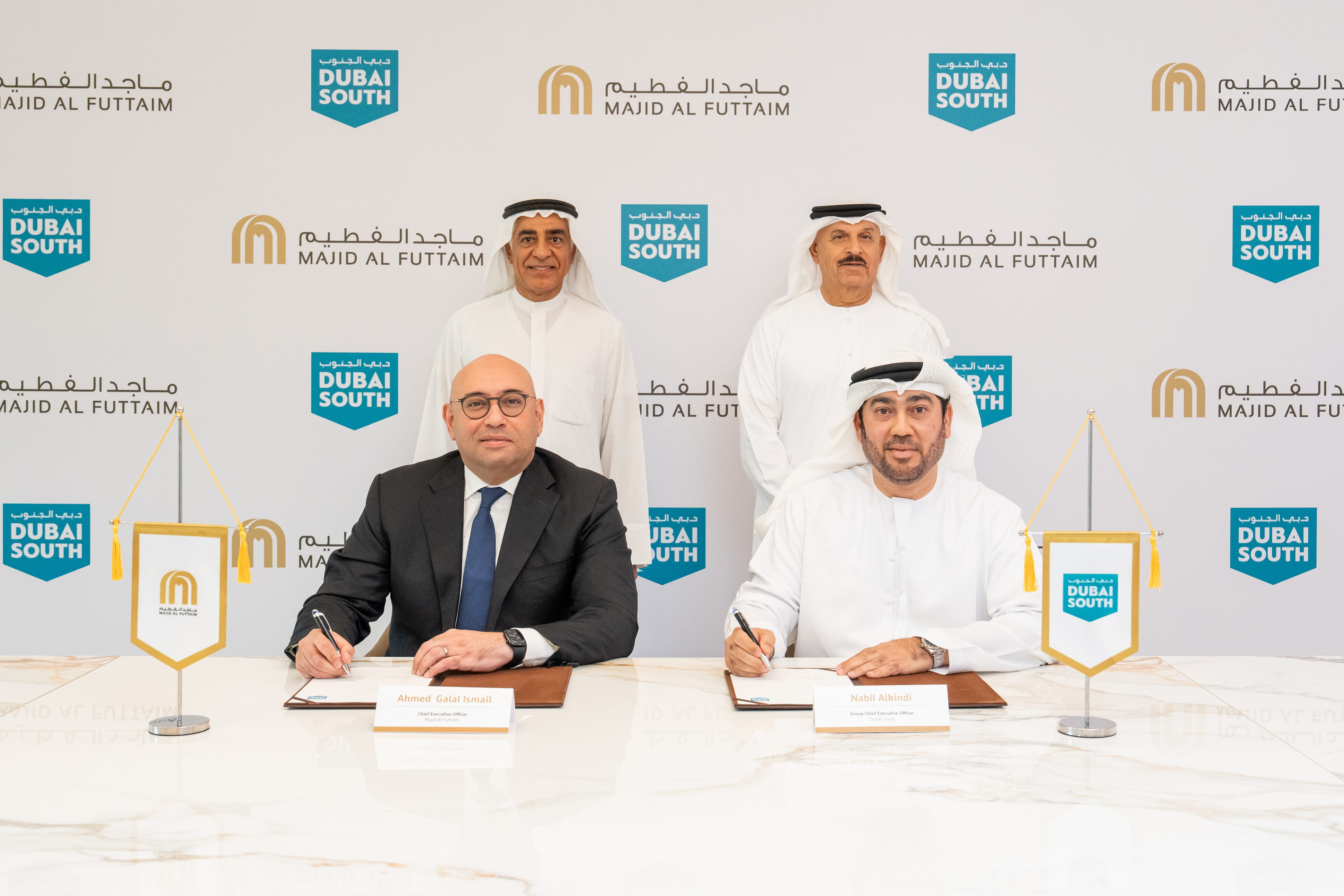 Official Government of Dubai Media Office photograph of a Dubai South and Majid Al Futtaim signing, four men at a table, both logos on the backdrop