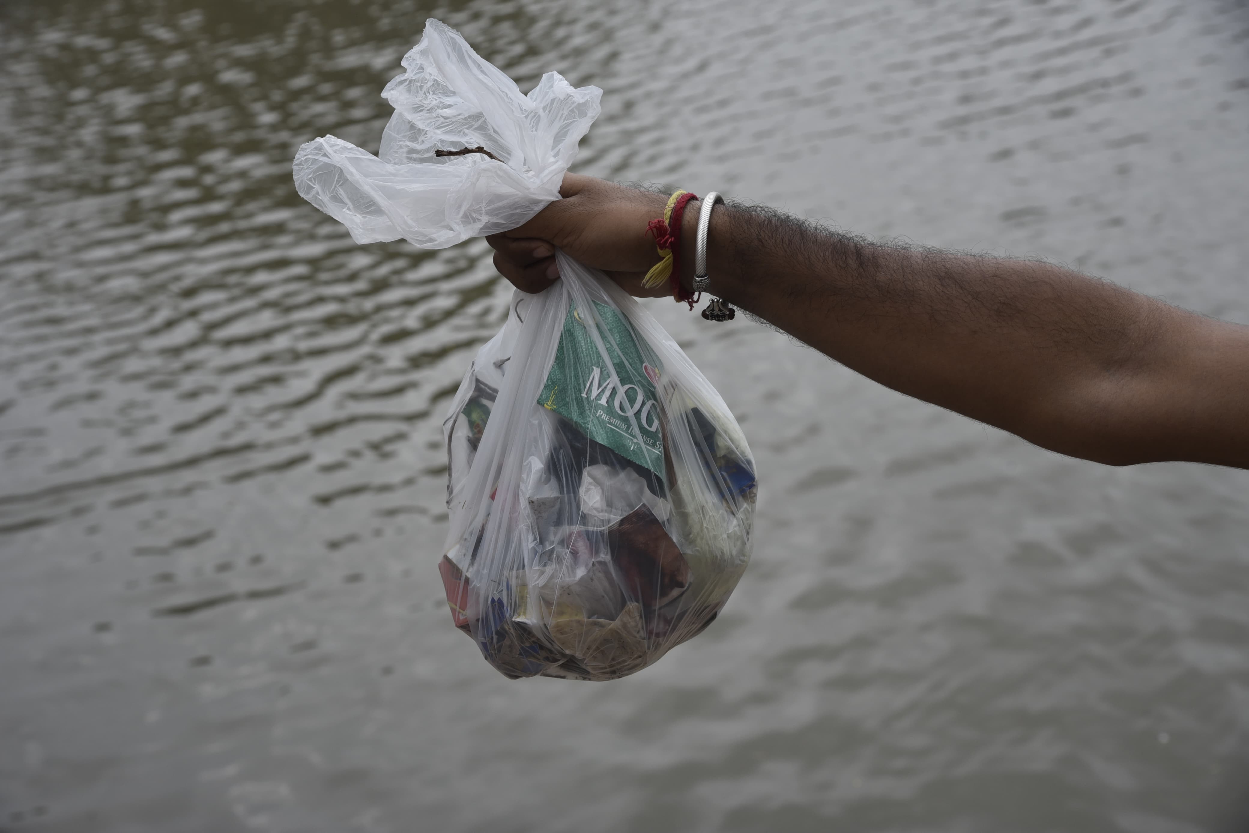 Removing plastic waste from the stairs at pond