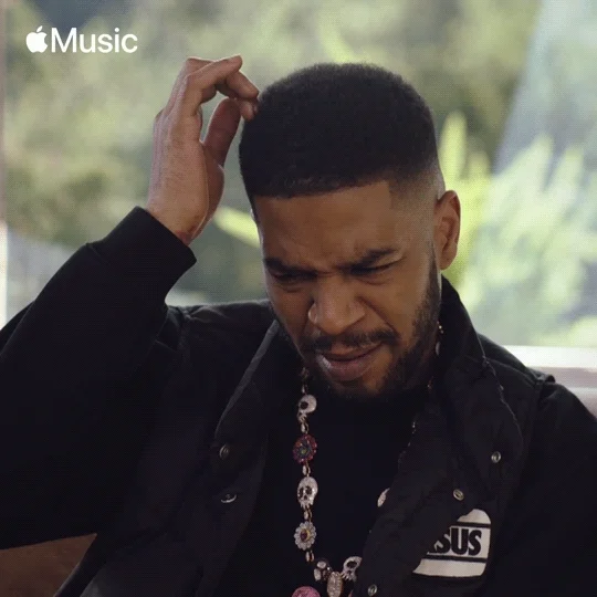 Rapper Kid Cudi scratching his head in confusion.