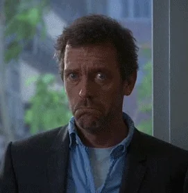 Dr. House raising his eyebrows and nodding slightly, showing a moment of reflection or realization.