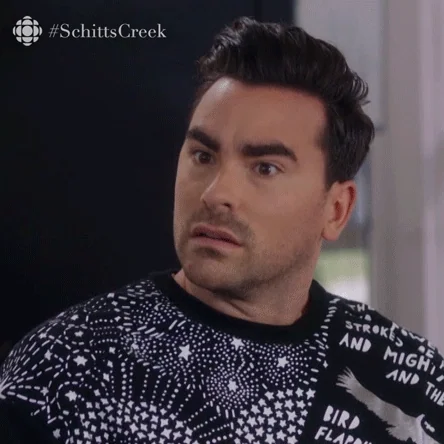 Dan Levy as David Rose on the TV show Schitt's Creek looks around nervously and says Yeah.