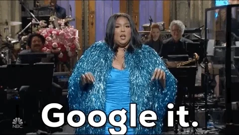 Lizzo dressed in a blue sparkly dress saying, 'Google it.'