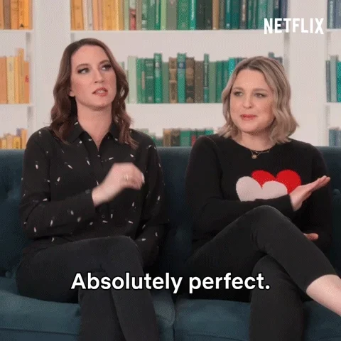 Two women on a couch saying, 