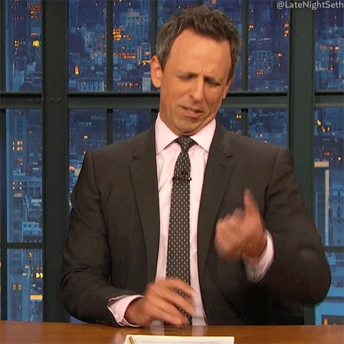 Seth Meyers in Late Night with Seth Meyers counting on fingers, looking confused.