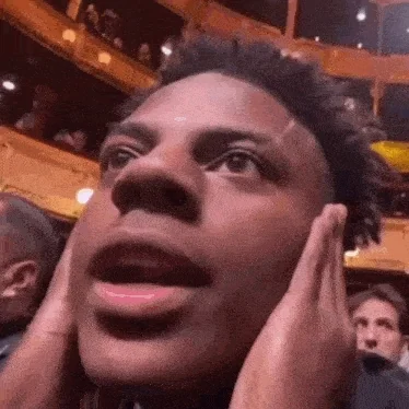 A man in suit yelling in shock while seated at a formal ceremony.
