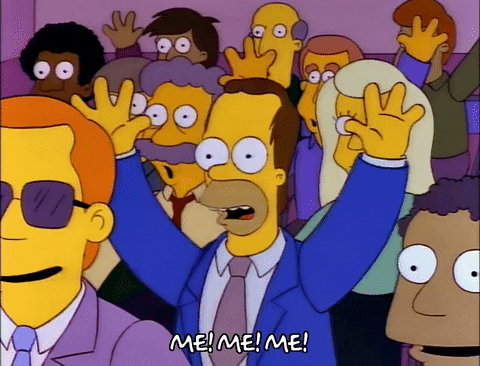 Homer Simpson in a crowd, pointing to himself saying 