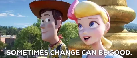 Woody and Bo Peep from Toy Story sit next to each other behind a gold statue. Text reads, 
