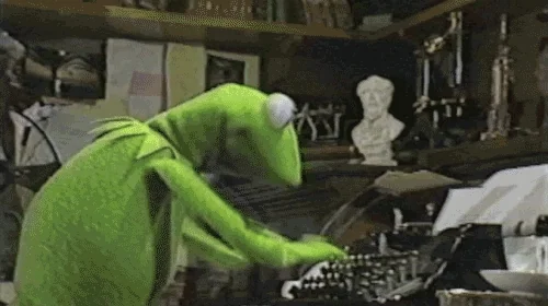 Kermit the Frog typing fast on a typewriter