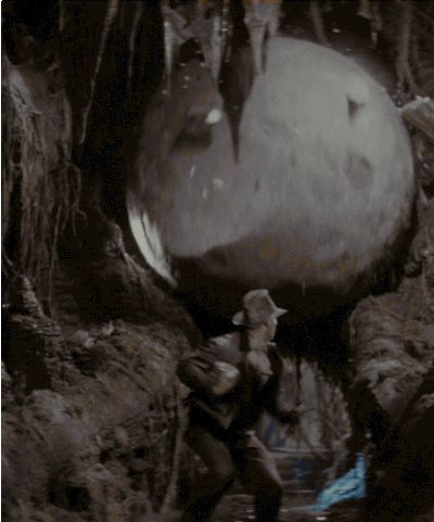 Indiana Jones running away from a boulder