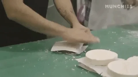 Two people making cheese