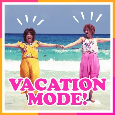 Two people, holding hands and smiling at the beach. The words 'vacation mode' flash in pink and orange.