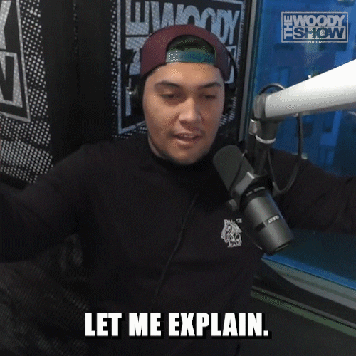 A podcast host in a studio saying, 'Let me explain.'