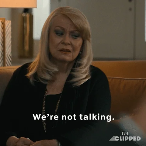 A woman looks upset, shakes her head, and says, 