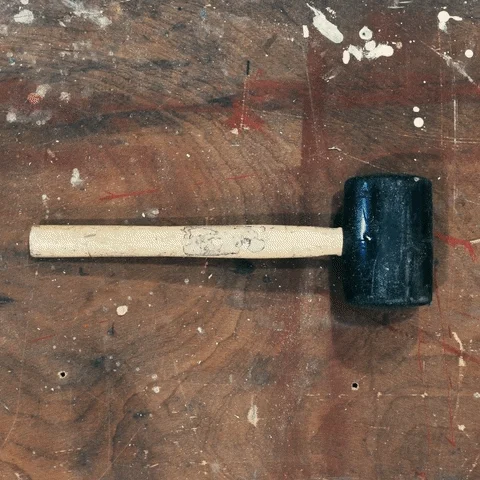 Various hand tools appear in a time lapse on a work bench.