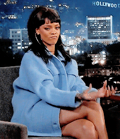 Rihanna rubbing her fingers together to mean money. 