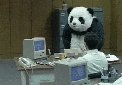 An angry panda throwing a computer off of an office desk.