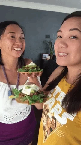 Two Registered Dietitians holding up plates of healthy meals