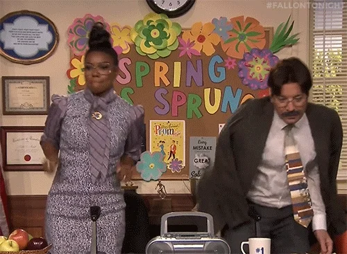 Jimmy Fallon and Janelle Monae dressed as teachers dancing in front of a class.