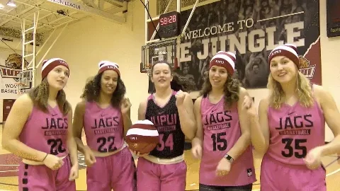 GIF of girls' basketball team pointing at their watches