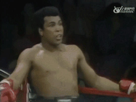Muhammad Ali taunting his opponent in the ring with a funny dance.