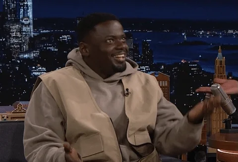 Actor Daniel Kaluuya smiles while talking and lifting one hand, then the other like the sides of an old scale.