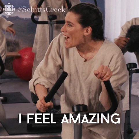Schitt's Creek Twila on exercise bike, saying I feel amazing