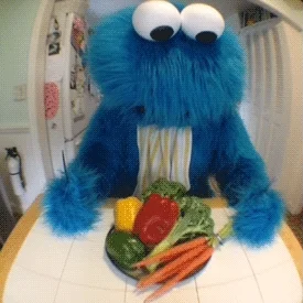 Cookie monster pushing vegetables away.