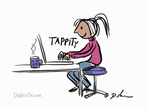 Woman at desk types on laptop