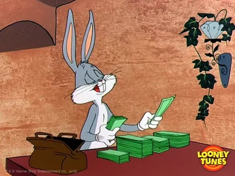 Bugs bunny seating at a desk, counting piles of dollar bills