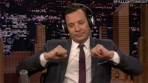 Jimmy Fallon with headphones on while dancing.