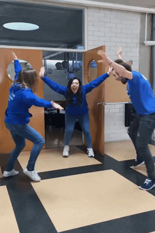 Three students jumping with excitement